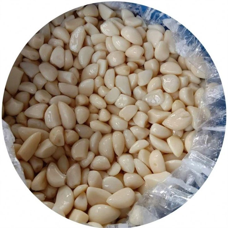 Salted peeled garlic cloves in brine in drums